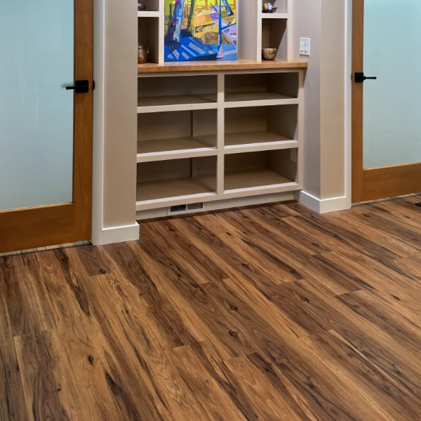 laminate flooring in front of built-in shelves and dual frosted glass doors