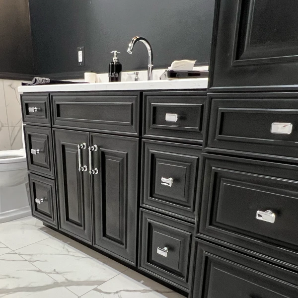shiny handles on dark, fancy bathroom cabinets