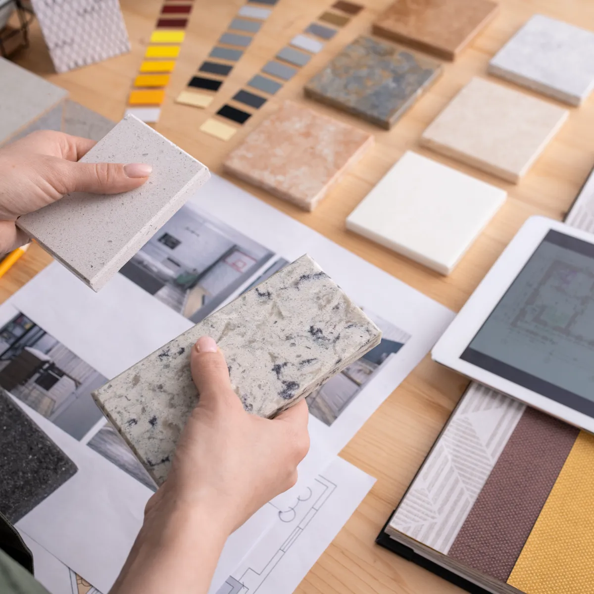 handling various samples of tiles next to a 2d design on a tablet