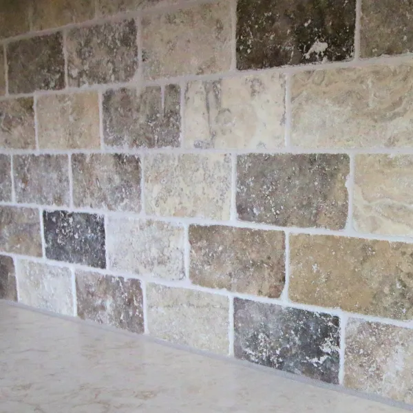 natural stone tiles in a rectangle on a kitchen backsplash
