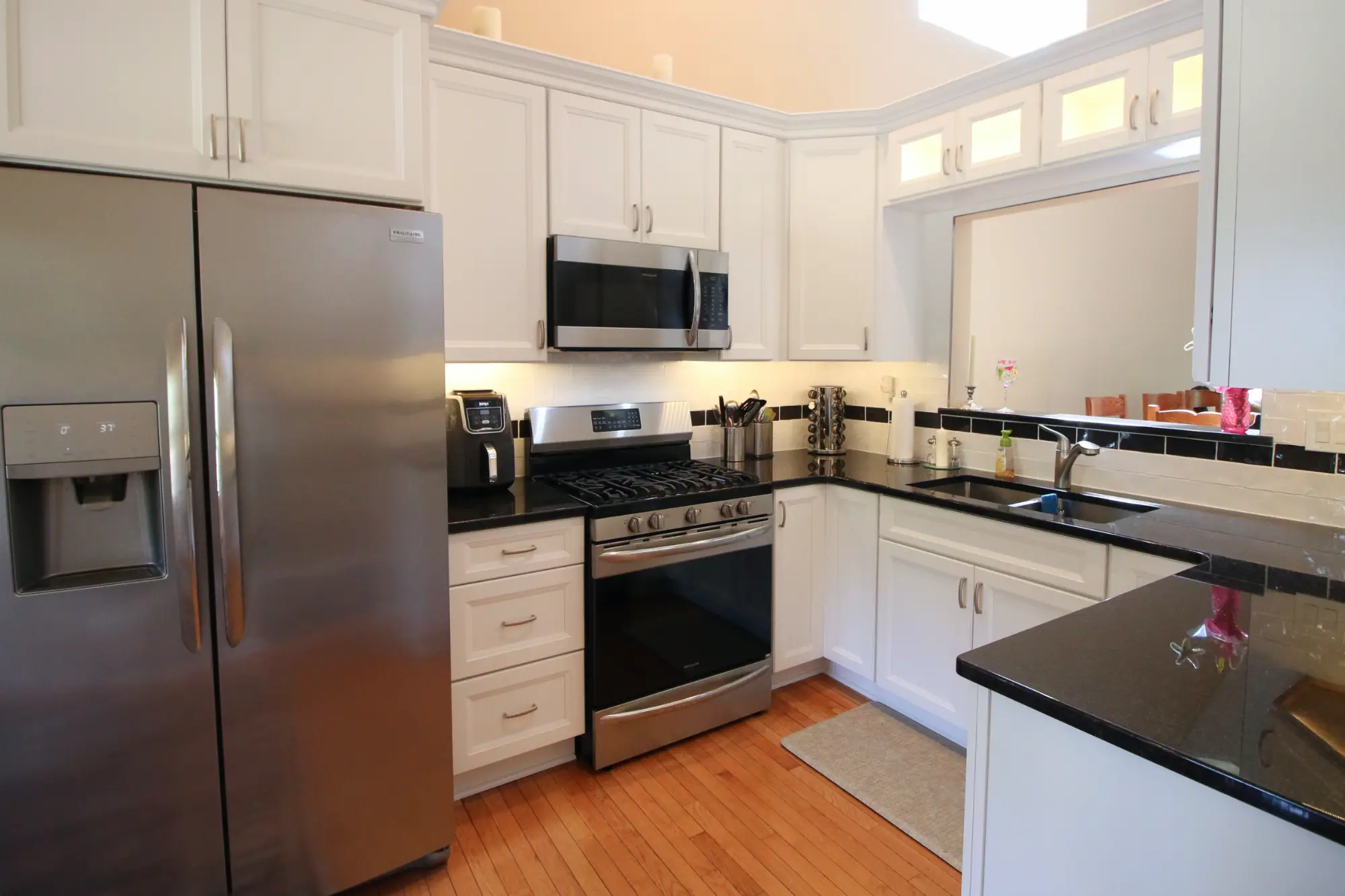 A contemporary kitchen remodel with white cabinets.