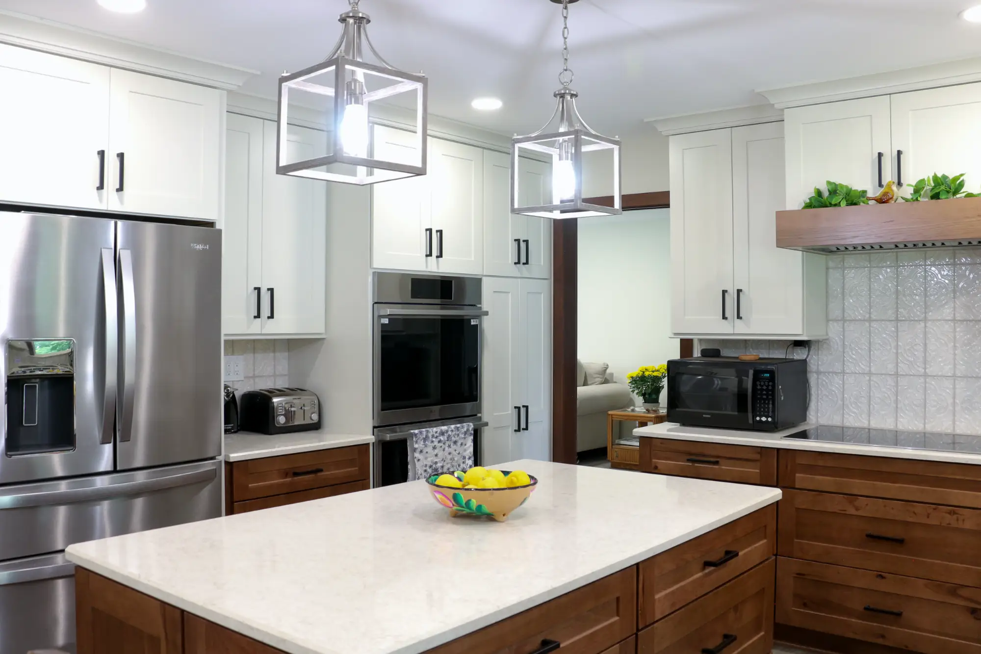 A modern kitchen remodel with white upper cabinets and medium wood tone lower cabinets.